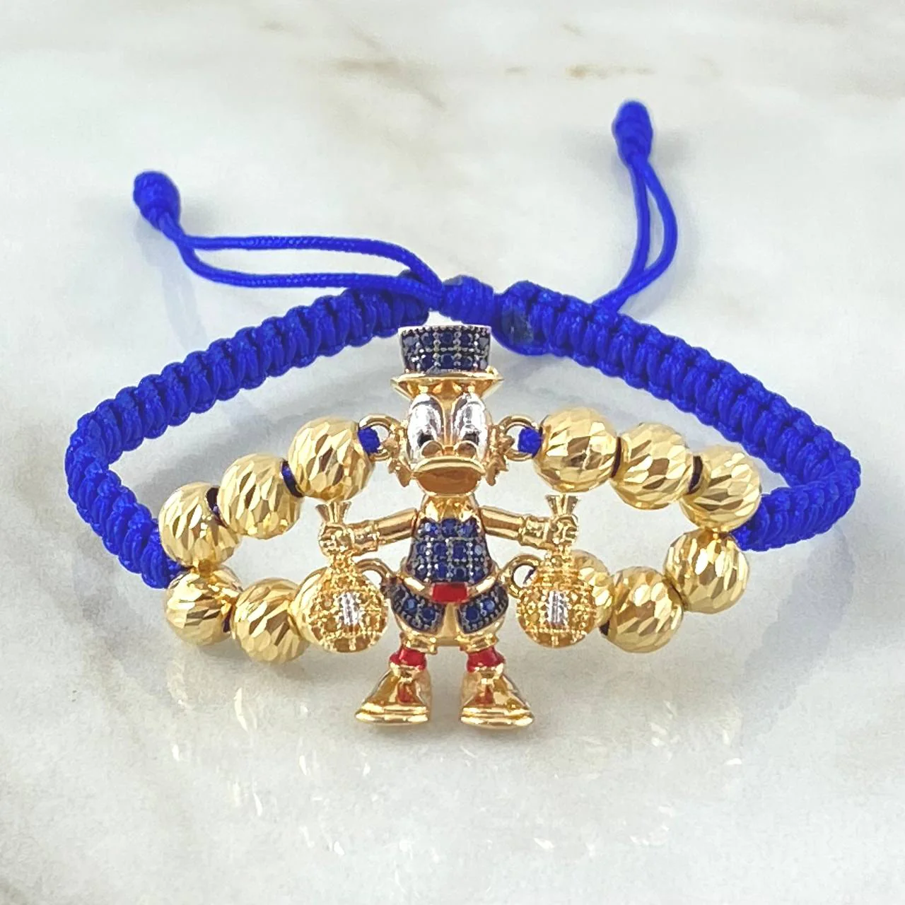 Pulsera Azul Herraje Pato Bolsas Dinero 7.5gr / Oro 18K ©
